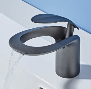 Modern LunaMist single-hole single-handle bathroom faucet by Home And Tower in gray, perfectly complementing a white bathroom sink.