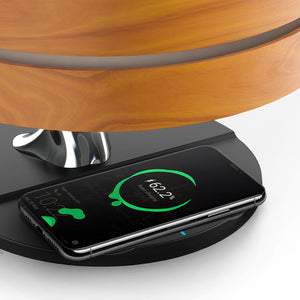 Close up of a phone charging on compass of life lamp.