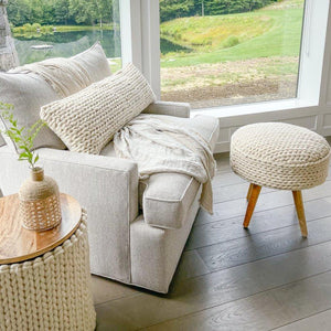 Handwoven Braided White Oversized Stool in a modern living room of a farm house.