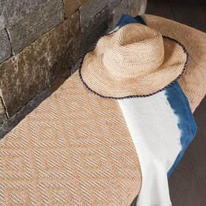 Close up of Handwoven Yellow Diamond Bench with a woven hat on it.