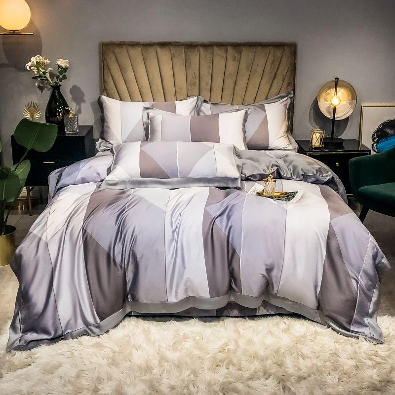 Purple Diamond Duvet Cover set with 4 diamond pillow covers. Two black bedside tables and un green bedside chair.