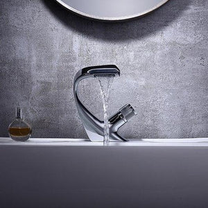 Soft wave water flow single rounded handle angel falls chrome bathroom faucet with a gray background on a white sink.