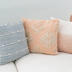 Pink Geometric Leaf Embroidered Throw Pillow besides of different throw pillows.