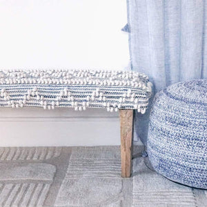 Recycled Indigo Denim Handwoven Bench With Wood Legs in a bedroom besides of Indigo Hand Crochet Pouf.