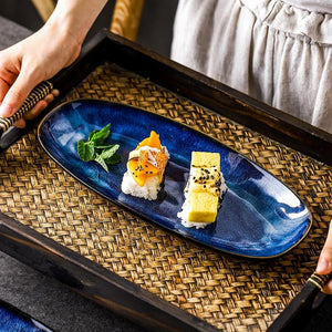 Sushi displayed in Eye Of Ocean Japanese Glazed Blue Long Plate.