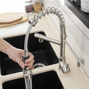 Pulling the hose down of Neil Pull-Down Springs Sprout Kitchen Sink Faucet in brushed nickel color.
