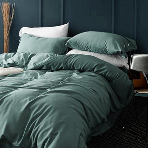 Eucalyptus Venetia Duvet Cover Set with two white pillow covers and two eucalyptus pillow covers in a blue bedroom.