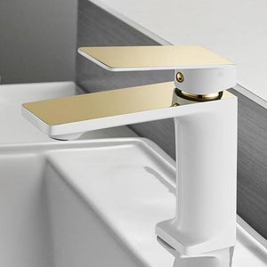 Mary Single-Hole Bathroom Faucet in white and gold color. Top body and top handles are in gold color.