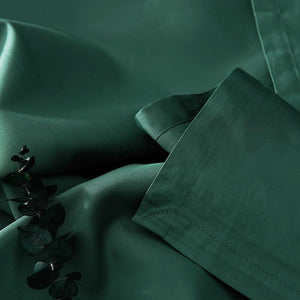 Green bed sheets with eucalyptus.