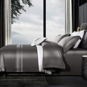 Bed with mountain view wearing Evelyn 1000TC duvet cover set, made of Egyptian Cotton featuring long staple in grey color.