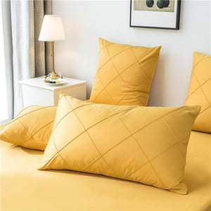 Microfiber made pillow covers in yellow color.