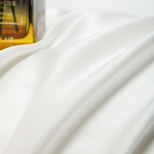 Close up of white bed sheets.