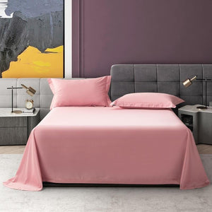 Stretched pink bedding sheets and two pink pillow covers.