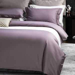 Beautiful purple juana comforter with white sheets and purple pillow covers.