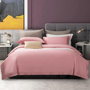 Pink Juana Egyptian Cotton Duvet Set with two table lamps and two bedside table in a purple room.
