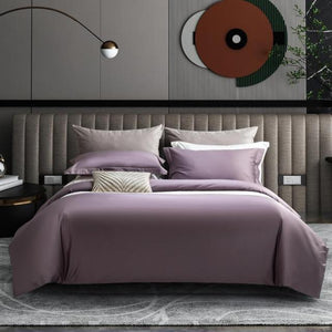 abstract wall covers with trees and purple egyptian cotton comforter with two purple pillow covers one white pillow cover and two gray pillow covers.