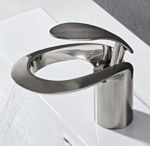 LumaMist brushed nickel bathroom faucet from Home And Tower. This is a unique, modern, and elegant single hole bathroom sink faucet, that has been mounted on a white bathroom sink.