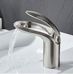 Sleek brushed nickel LunaMist bathroom faucet from Home And Tower, capturing modern elegance on a white sink backdrop.