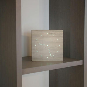 Ash analogue digital Clock on wooden wall shelves stand.
