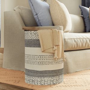 Handwoven Indigo Striped Storage Side Table with the tabletop open in a living room.