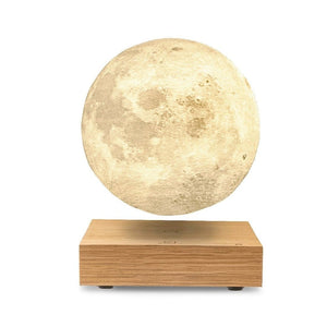 White Ash floating moon lamp with yellow light.