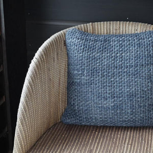 Handwoven Luxe Indigo Throw Pillow On a Beige Color Chair.