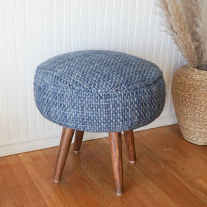 Front view of Handwoven Luxe Indigo Oversized Stool in a bedroom.
