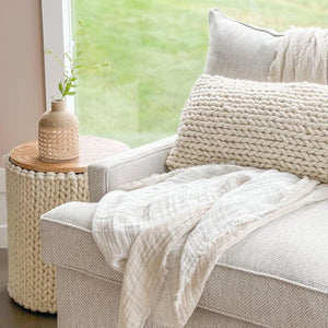 Handwoven Braided White Pillow on white sofa with Anaya's Handwoven white table side in a farm house.