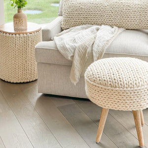 Handwoven Braided White Oversized Stool in a living room with a cream color sofa.