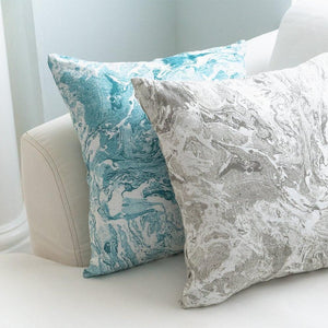 Turquoise and Gray Marbled Linen Throw Pillows on cream color sofa.