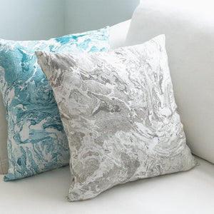 Grey and Turquoise Marbled Linen Decor Pillows on a cream color sofa.