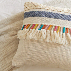 Top view of Rainbow Tassel Cotton Boho Throw Pillow on a bed.