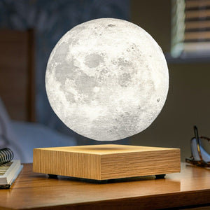 white ash magnetic moon lamp on a bedside table with white light.