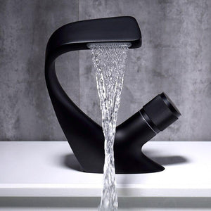 Angel Falls Single Rounded Handle Matte Black Bathroom Faucet with soft waves water flow on a white bathroom vessel