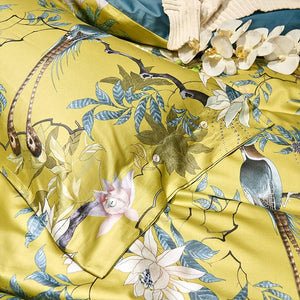 birds of afrodita printed on a yellow pillow cover made of egyptian cotton. There are flowers printed and other animals.