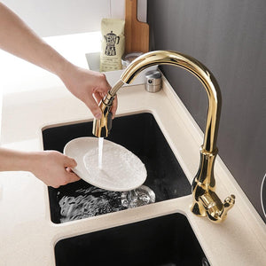 Hose pulled out of Max Swivel Spout Pull-Down Single-Hole Kitchen Sink Faucet in gold color.