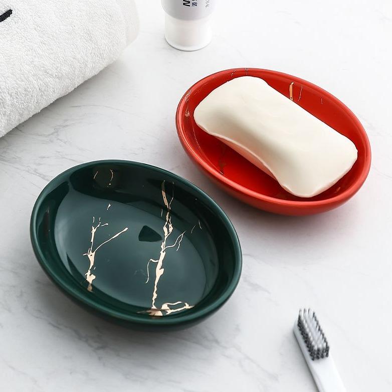 Scallop shaped red and green glazed soap dishes.