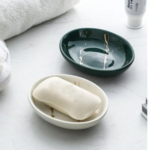 Scallop shaped white and green glazed soap dishes.