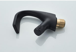 Black bathroom faucet with a single rounded handle, cold and hot water flow.