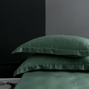 White pillow covers in green color. Pillow covers do not come with filling.