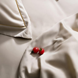 Flat bed sheet in cream color.