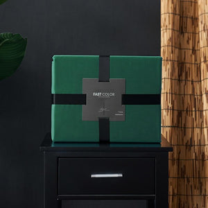Green Venetia Duvet in a box on a black bedside table.