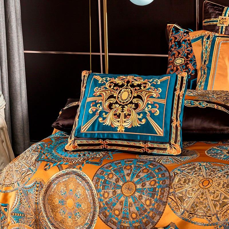 Orange otto duvet cover set with mandalas printed and pillow covers in a bedroom with a floor lamp and a bedside table.