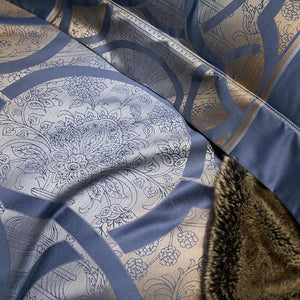 Close view of blue bedding sheets and pillow cover.