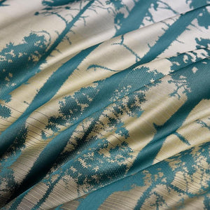 Close up of bed sheets in ocean color.