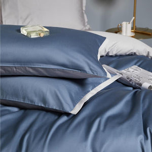 Ava Reversible Duvet Cover Set made of Egyptian Cotton in Pearl and Steel color.