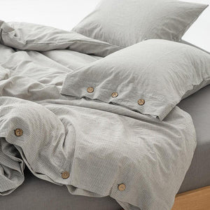 Pillow covers, duvet and fitted bed sheet from Olivia Bedding Set in gray color.