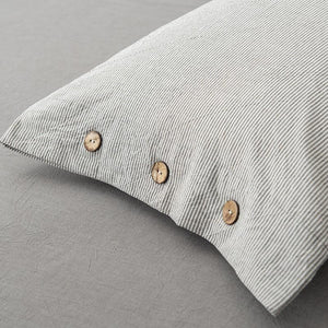 Grey color pillow covers with buttons.