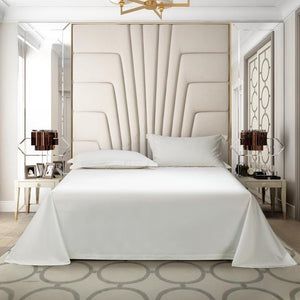 White bedding sheets with two white pillow covers and two bedside tables.