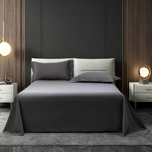 Gray bed sheets with white bedside tables and table lamps.